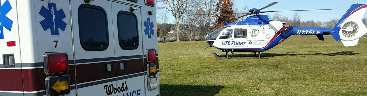 photo of a Wood's Ambulance transport vehicle and Life Flight helipcopter